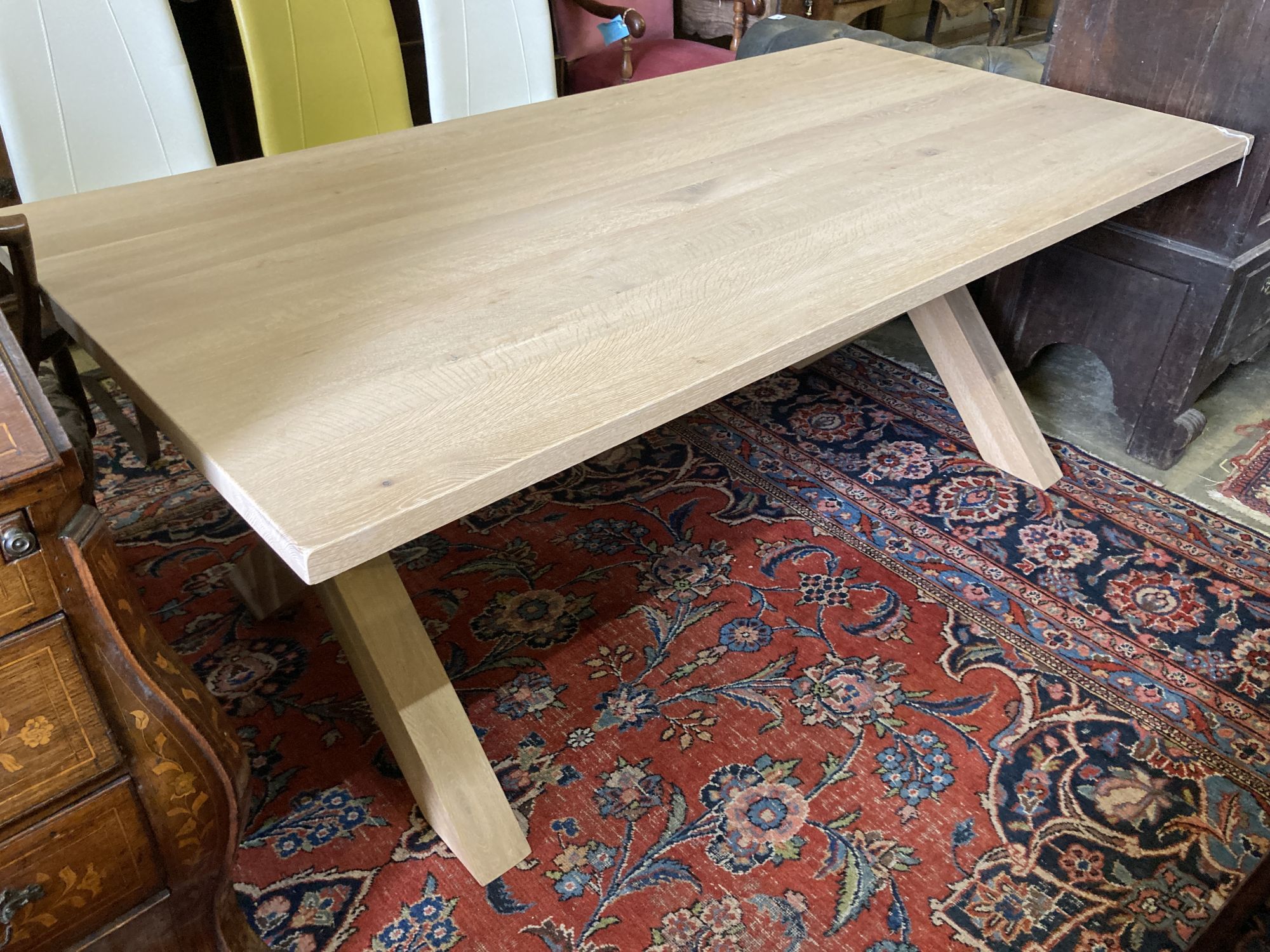 A contemporary oak X-framed dining table, length 200cm, depth 100cm, height 76cm